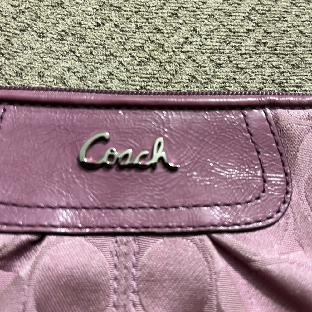 Coach wristlet.  EUC. Pinkish/mauve color.  Approximately 8.5 x 5.5